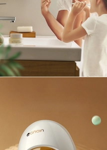 Close-up of Gonain white egg-shaped toothpaste dispenser with family bathroom scene