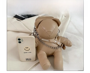Size comparison of khaki bear PU leather bag with chain strap next to a mobile phone