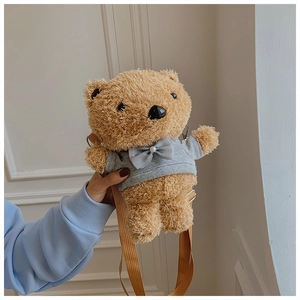 Detail of light brown plush teddy bear bag featuring a grey hoodie and adjustable strap