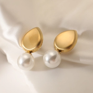18K gold plated teardrop pearl earrings displayed on white silk and stone base