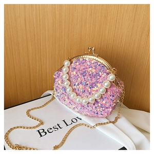 Detail showing pink sequin shell bag with large pearl handle and golden chain strap