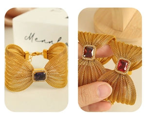 Detail of gold mesh bow bracelet with large rectangular gem and crystal border