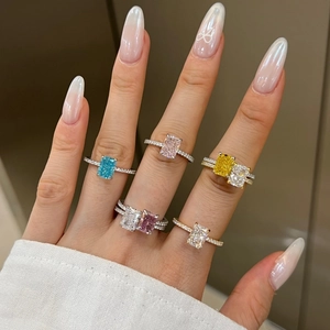 Macro shot of S925 silver rings with radiant cut colorful zircons on a hand