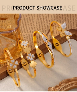 Detailed showcase of four gold-plated titanium bangles with clover and butterfly charms