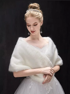 Elegant white faux fur bridal shawl accessory shown on a model against a black background