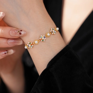 Close-up of vintage floral bracelet with white pearls and colorful zircon stones