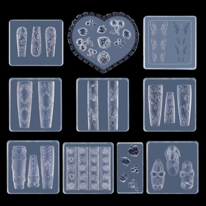 Detail view of 10 silicone nail art molds with flowers, butterflies and heart designs