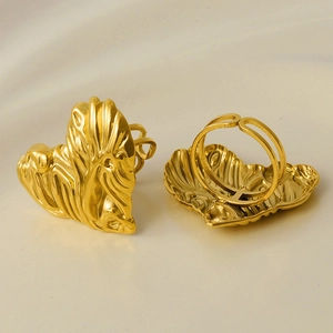 Detailed view of 304 stainless steel gold heart ring and adjustable open band on beige cloth
