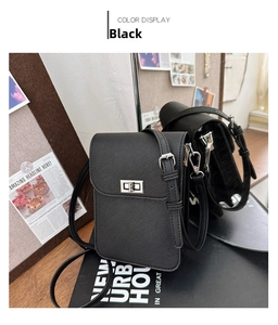 Detail of black Saffiano leather phone crossbody bag with silver twist lock on wood surface