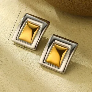 Macro view of geometric two-tone steel earrings with 3.6cm x 2.7cm size details