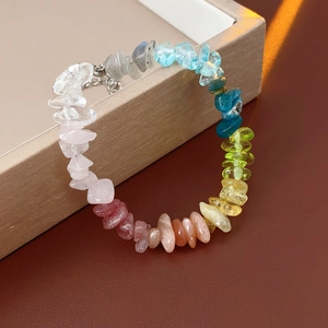 Macro shot of colorful natural stone beaded bracelet with gradient rainbow crystals