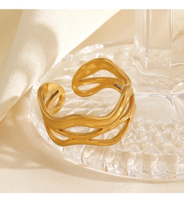 Macro detail of 18K gold plated multi-layer wave open ring on a wavy glass tray