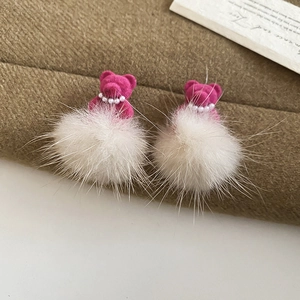 Detail of rose red flocked bear earring with white faux pearl necklace and soft fur pompon