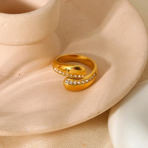 Detailed view of gold plated stainless steel open ring with sparkling white zircon stones