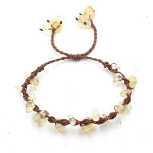 Detailed view of handmade brown cord bracelet with translucent yellow citrine stones