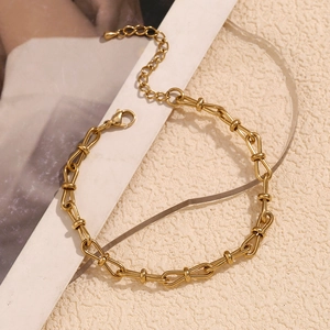 Detail of 14K gold plated butterfly bow chain anklet with lobster clasp and extender