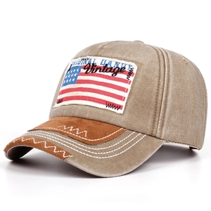 Detail of USA flag patch embroidery and zigzag contrast stitching on khaki baseball cap