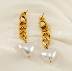 Detailed macro view of 18K gold-plated chain earrings with elegant white heart pearl charms