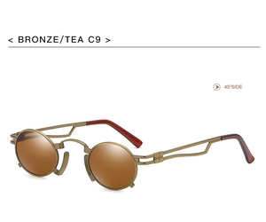 Detail view of vintage bronze metal sunglasses with tea lenses and hollow temple design