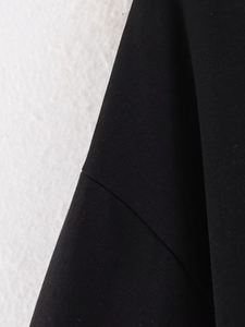 Close-up of black T-shirt showing fine stitching and premium jersey fabric texture