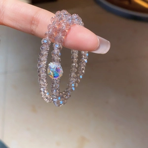Macro detail of double-layer lavender crystal bead bracelet with iridescent focal bead