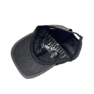 Internal detail of washed cotton baseball cap with sweatband and adjustable metal buckle