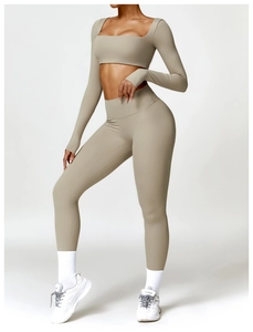 Detail of high-waisted yoga pants and long sleeve crop top with thumbholes in khaki