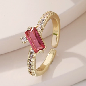 Close-up of gold-plated ring with a rectangle red gemstone and micro-pave zircons