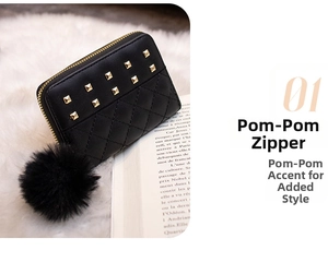 Close-up of black quilted wallet featuring gold studs and a fluffy faux fur pompom charm