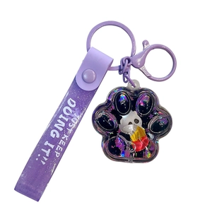Purple cat paw quicksand keychain with panda figure and Just Keep Doing It strap