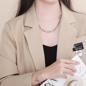 Silver paperclip chain necklace and bracelet set with OT toggle clasp on a model