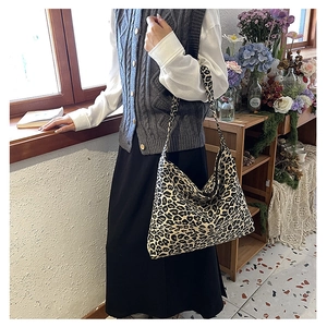 Lifestyle shot of woman carrying a large capacity leopard print canvas tote bag
