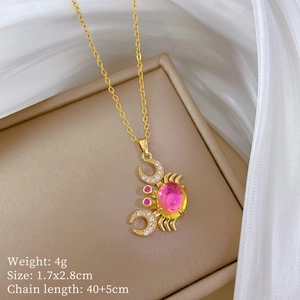 Close-up of golden crab pendant with crystals, showing size 1.7x2.8cm and 4g weight detail