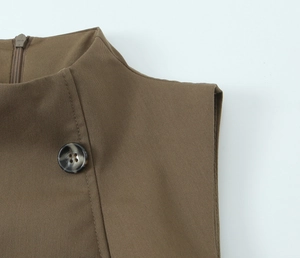 Detail of coffee brown sleeveless top with twill fabric texture and resin button
