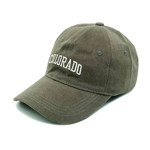 Detail of embroidered COLORADO logo on washed cotton baseball cap in olive green