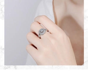 Close-up of a silver ring with a square halo setting and sparkling cubic zirconia stones
