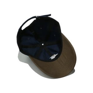 Detail view of cotton baseball cap interior with metal buckle and adjustable strap