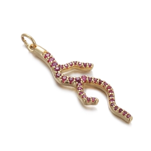 Detailed view of golden coral branch pendant with pink gemstone inlay on white background