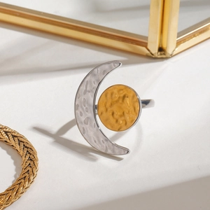 Macro detail of sun and moon open ring with textured hammered finish in gold and silver