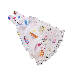 Detailed view of floral pet dress with layered lace hem and a large white mesh bow