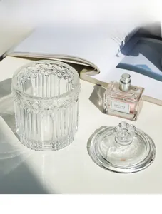 Detailed view of clear glass storage jar with flower relief and vertical stripe texture