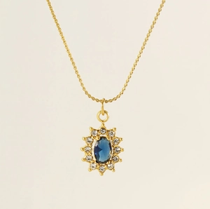 Close-up of 18K gold stainless steel sunflower necklace with deep blue zircon pendant