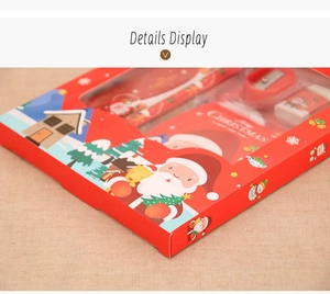 Close-up of Christmas stationery set in red window box with festive Santa illustrations