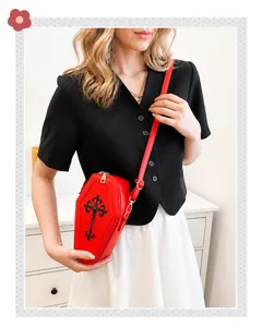 Gothic red coffin shaped crossbody bag with black floral cross and adjustable strap