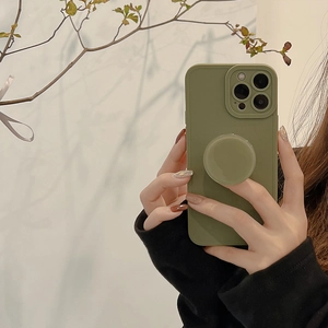 Detail of army green silicone iPhone case set with matching circular pop socket stand