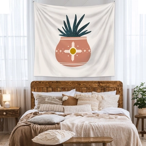 Detail of bohemian tapestry featuring a potted blue plant over a cozy bedroom bed