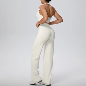 Detail of cross back sports top and high waist wide leg yoga pants in off-white