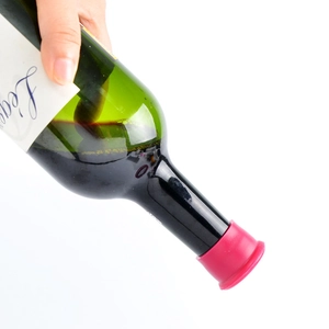 Food grade red silicone beer bottle cap sealing wine stopper shown on a tilted glass bottle