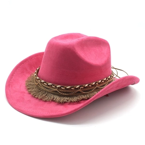 Detailed view of pink cowboy hat featuring bohemian gold chain and fringe band decoration