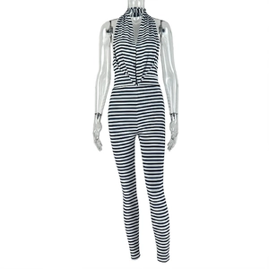 Close-up of black and white striped halter jumpsuit with cowl neck and side ruching details